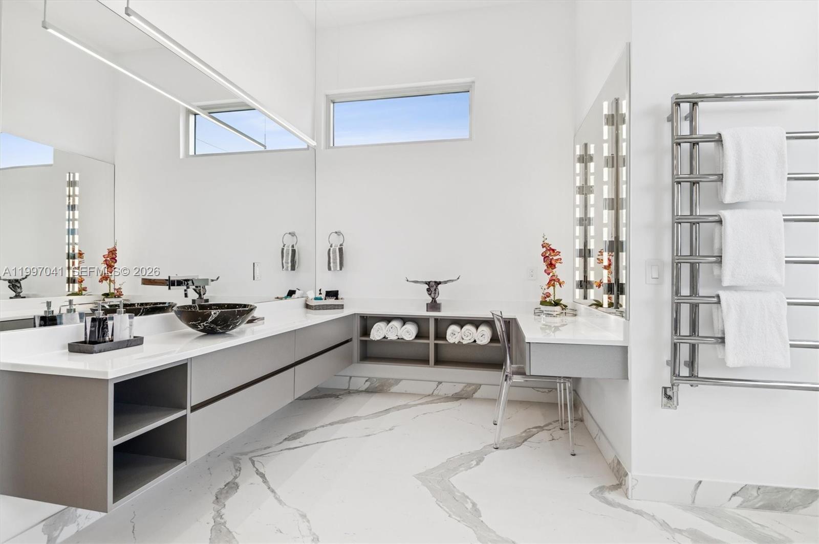 2628 Marcinski Road Jupiter, FL 33477 - Photo 29 of 50 a kitchen with a sink and chairs