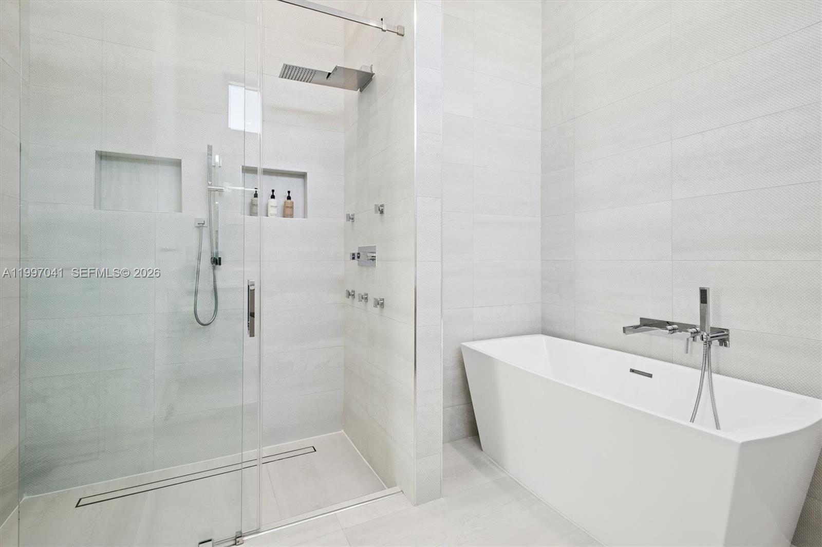 2628 Marcinski Road Jupiter, FL 33477 - Photo 35 of 50 a bathroom with a bathtub and shower