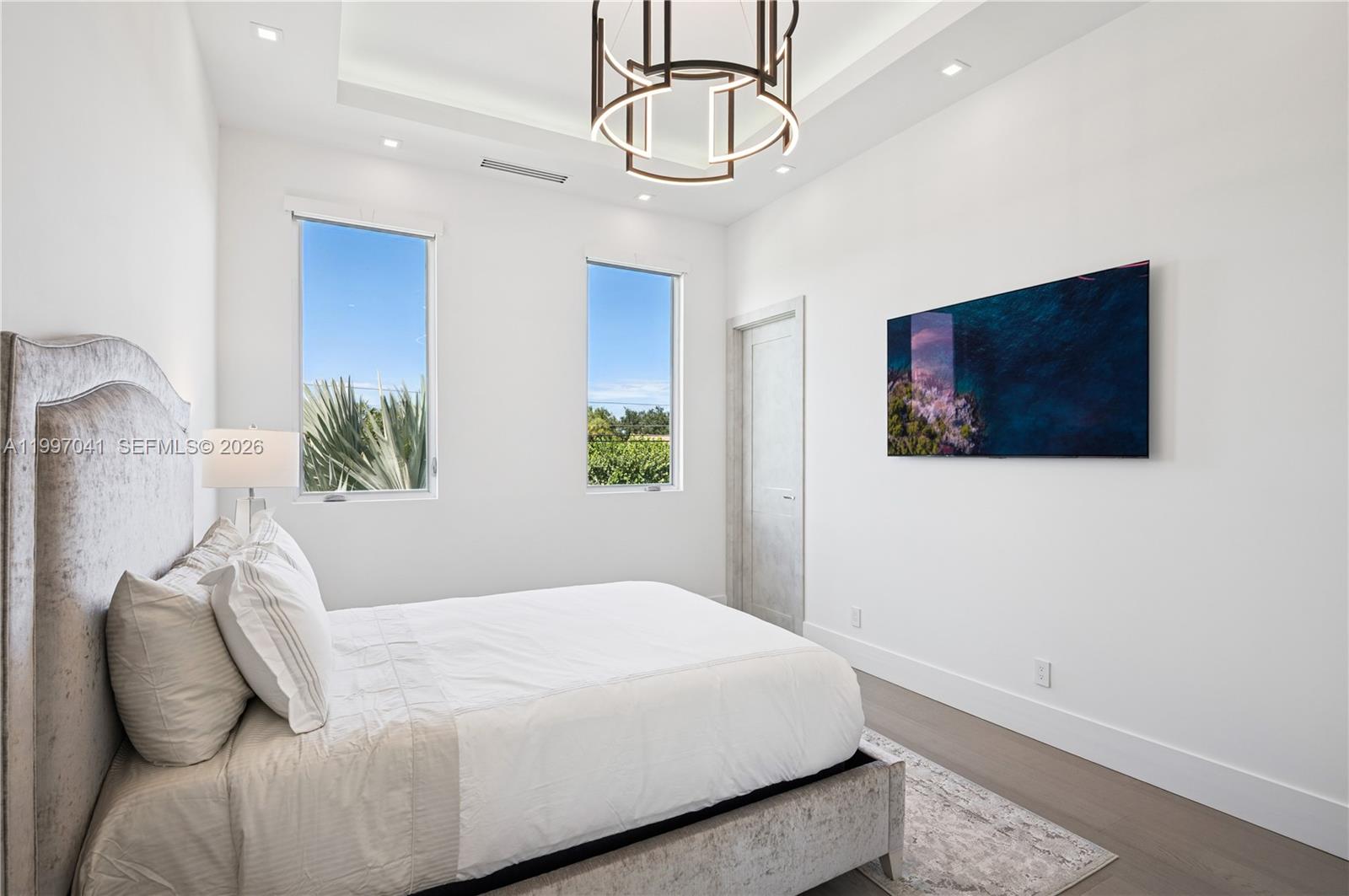 2628 Marcinski Road Jupiter, FL 33477 - Photo 38 of 50 a bedroom with a bed and a painting on the wall