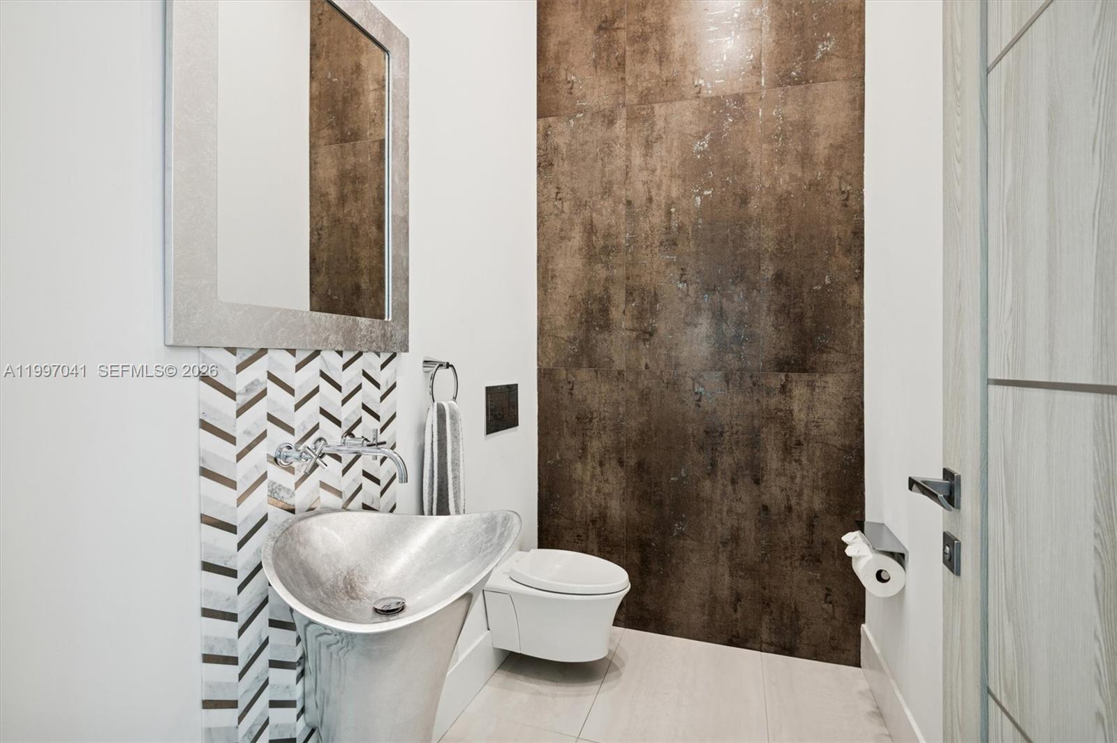 2628 Marcinski Road Jupiter, FL 33477 - Photo 40 of 50 a bathroom with a toilet and a sink