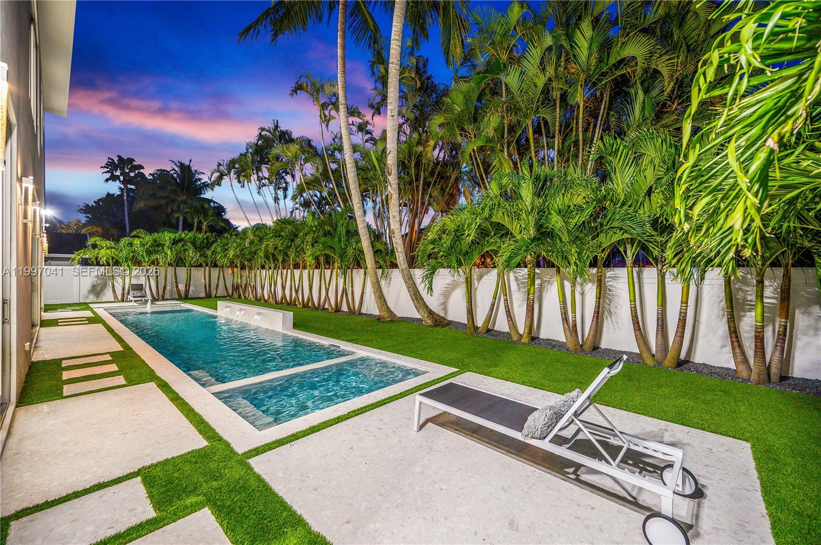 2628 Marcinski Road Jupiter, FL 33477 - Photo 47 of 50 a view of a tennis ground with a large trees