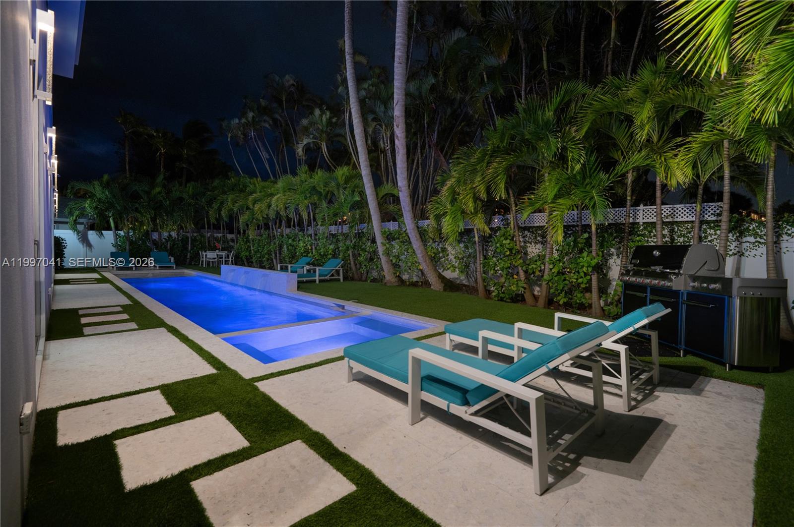 2628 Marcinski Road Jupiter, FL 33477 - Photo 48 of 50 a view of a backyard with chairs