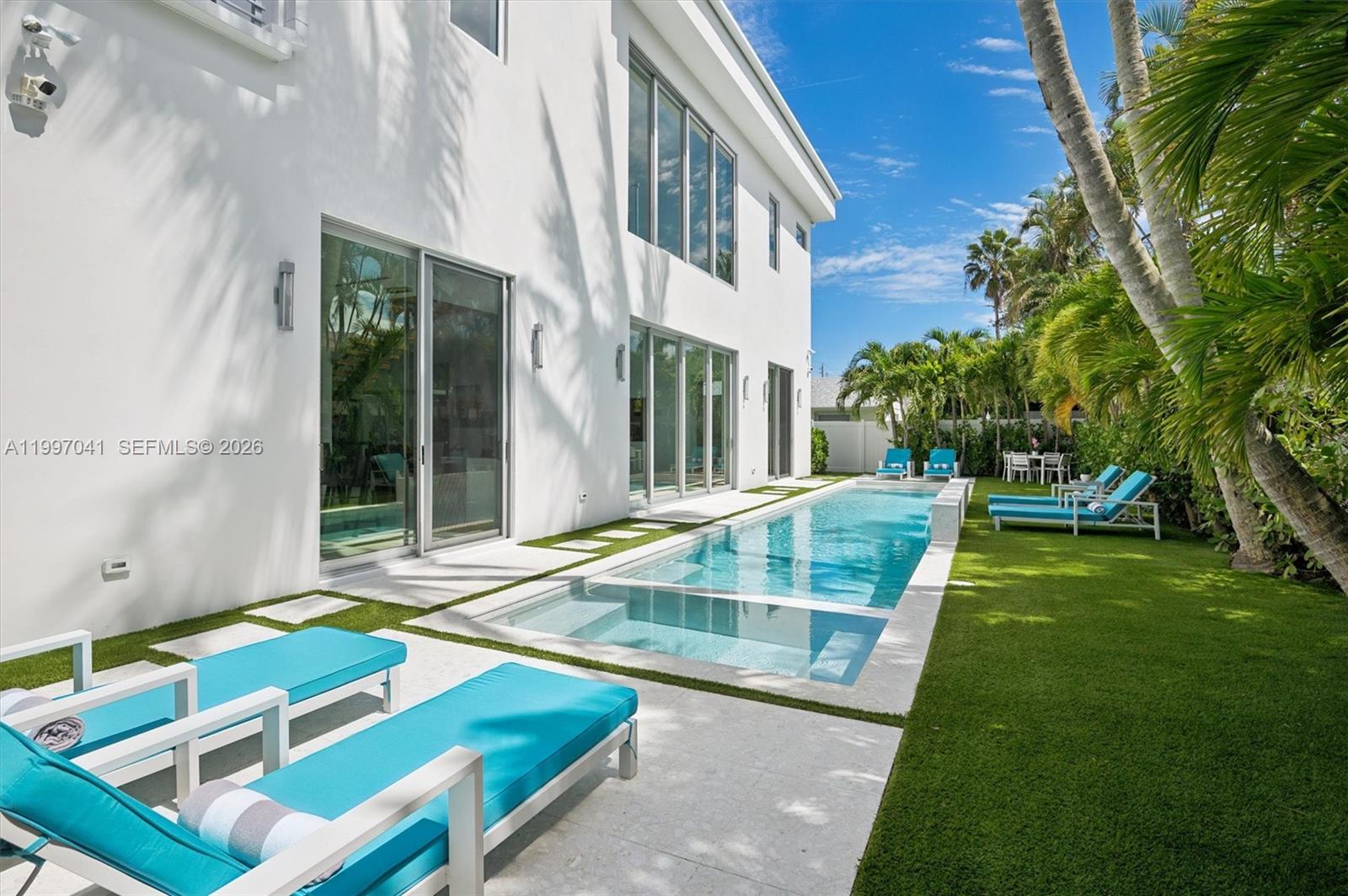 2628 Marcinski Road Jupiter, FL 33477 - Photo 7 of 50 a view of an house with backyard and swimming pool