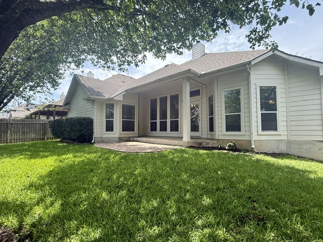 20724 Kearney Hill Road Pflugerville, TX 78660 - Photo 5 of 40 Expansive backyard featuring a lush lawn and mature tree canopy
