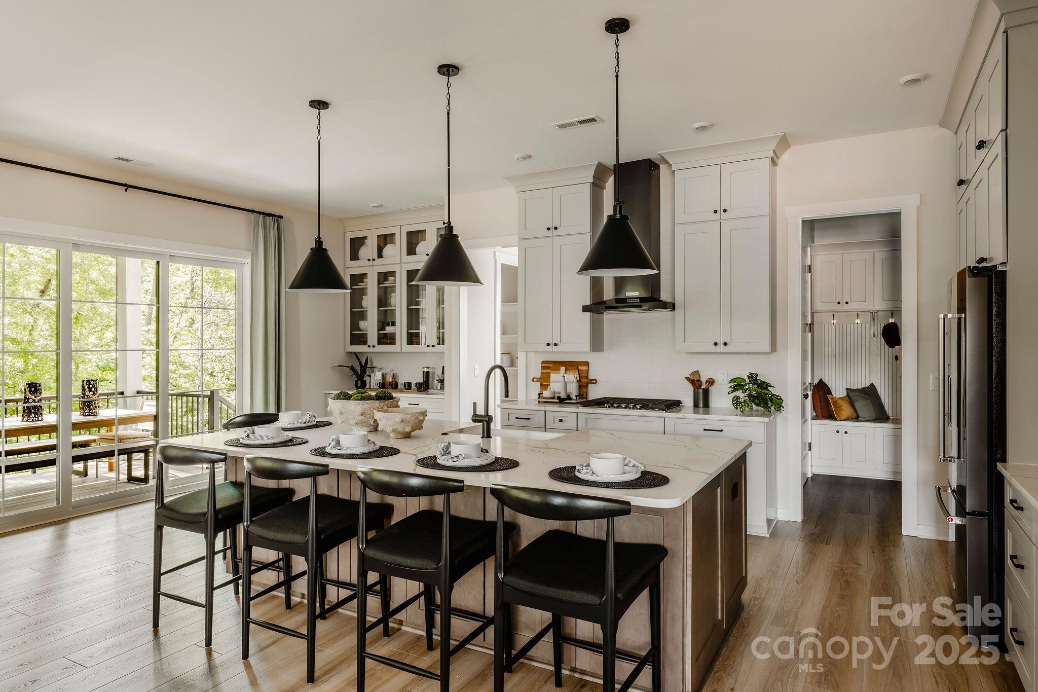 14 Huntersville-Concord Road, Unit COVINGTON Huntersville, NC 28078 - Photo 4 of 13 a view of a dining room and livingroom with furniture wooden floor a chandelier