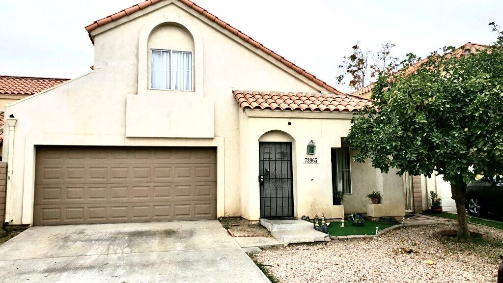 73965 Santa Rosa Way Palm Desert, CA 92260 - Photo 1 of 5 a front view of a house with a garden