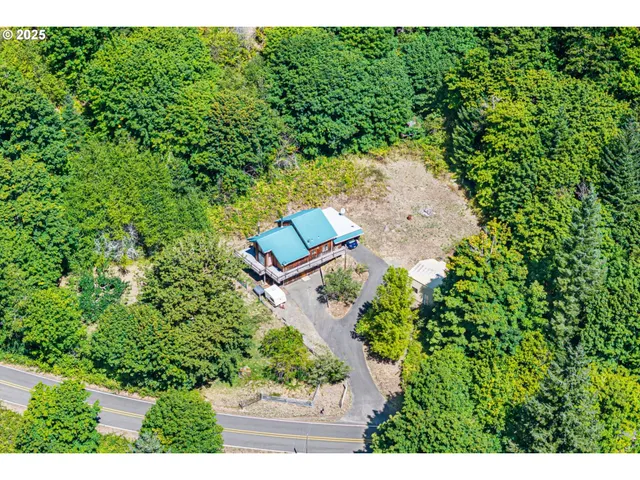an aerial view of a house with a yard