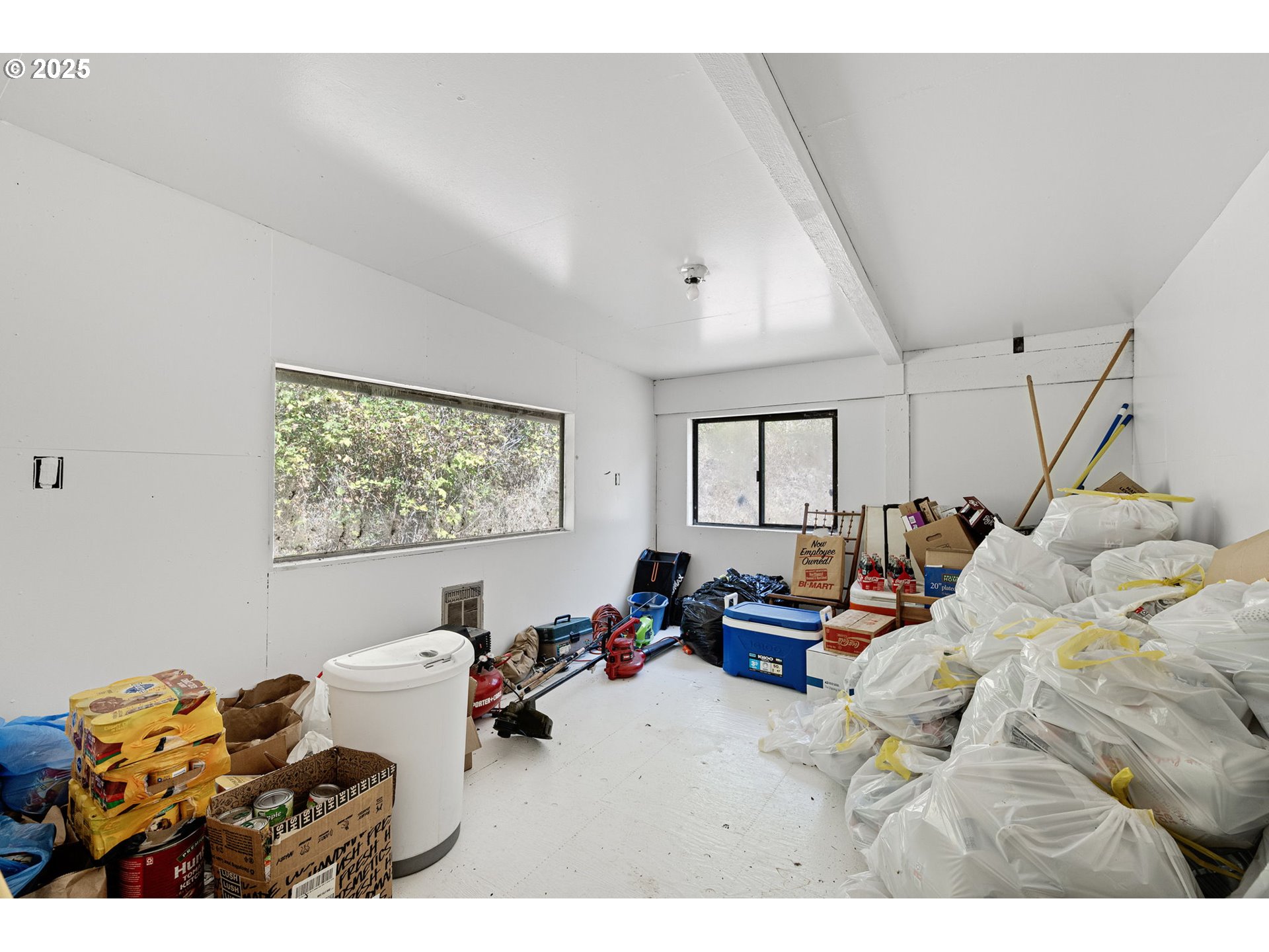 89731 Indian Creek Road Swisshome, OR 97480 - Photo 18 of 46 a bedroom with furniture and a large window