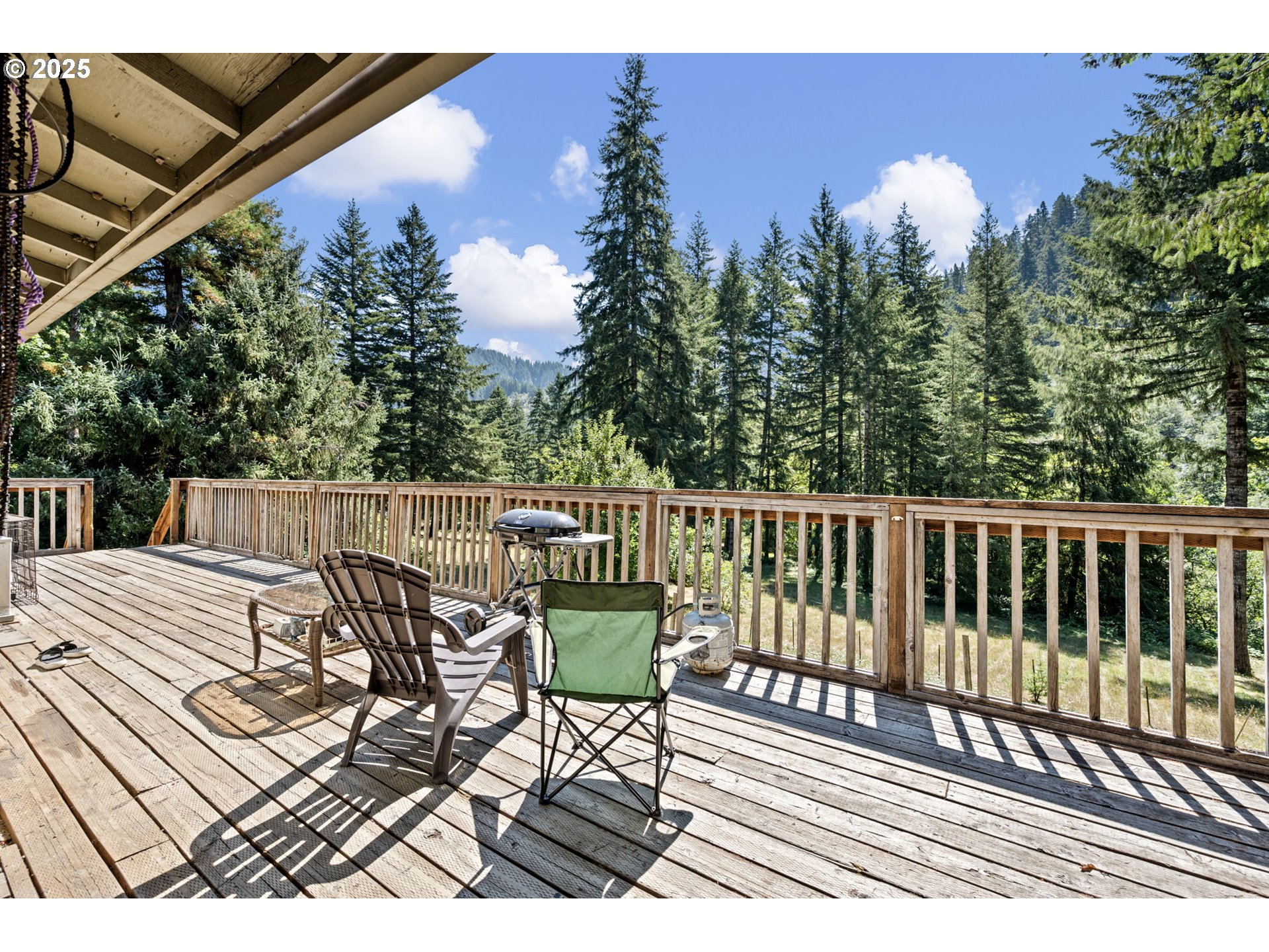 89731 Indian Creek Road Swisshome, OR 97480 - Photo 22 of 46 a view of balcony with wooden floor and outdoor seating