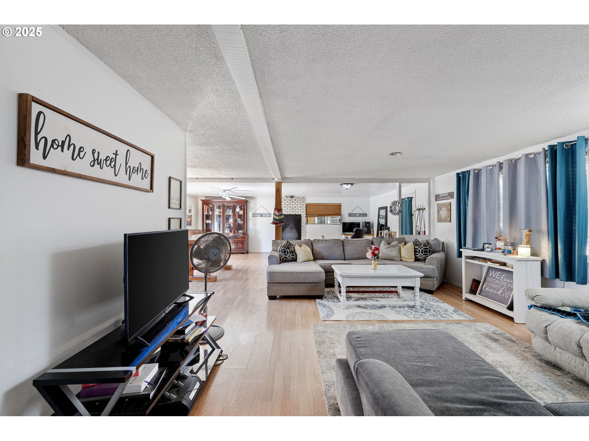 89731 Indian Creek Road Swisshome, OR 97480 - Photo 25 of 46 a living room with furniture a flat screen tv and a wall painting