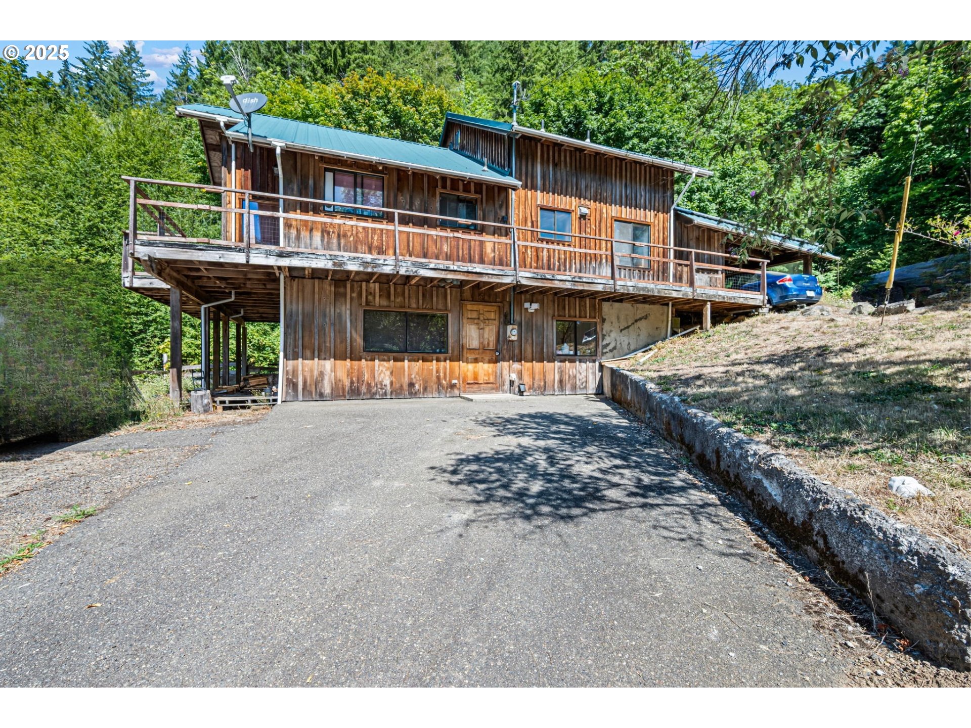 89731 Indian Creek Road Swisshome, OR 97480 - Photo 5 of 46 a front view of a house with a yard