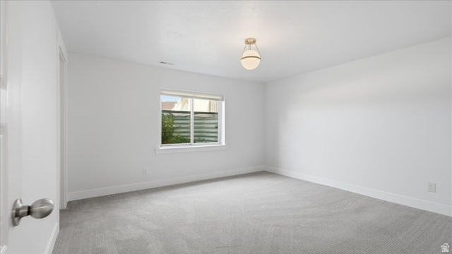 2038 East Ranch Road Eagle Mountain, UT 84005 - Photo 32 of 66 Spacious room featuring light gray carpet flooring, white painted walls, a flush-mount ceiling fixture, a window with horizontal blinds, and white trim molding