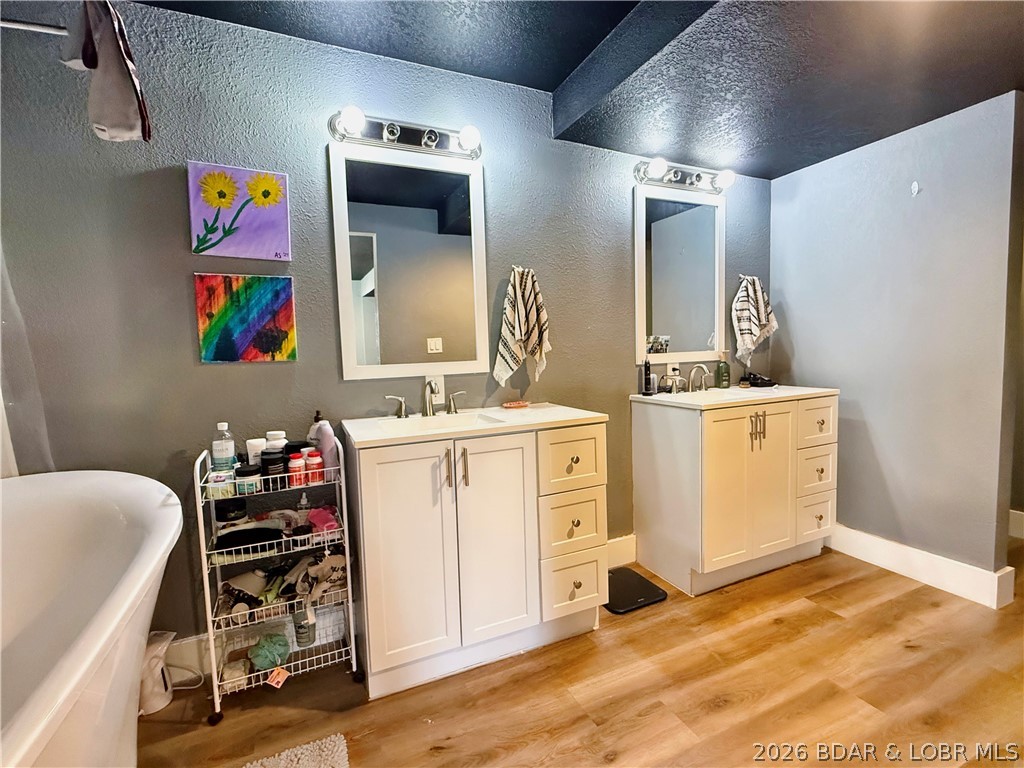 876 Malibu Road Osage Beach, MO 65065 - Photo 4 of 37 Double vanity and soaking tub in the primary suite