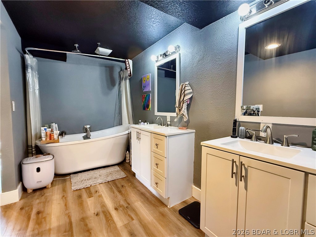 876 Malibu Road Osage Beach, MO 65065 - Photo 6 of 37 Double vanity and soaking tub in the primary suite