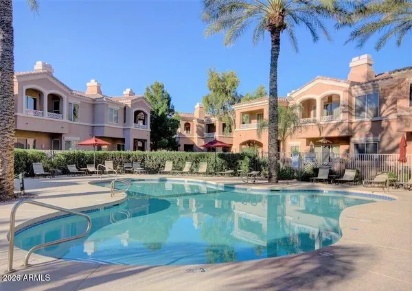 a front view of residential houses with yard and swimming pool