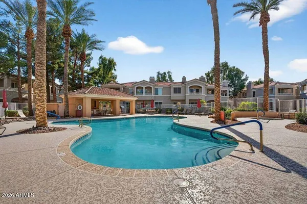 a view of a swimming pool with a lounge chairs
