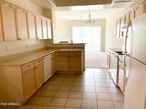 a kitchen with a sink a stove and cabinets