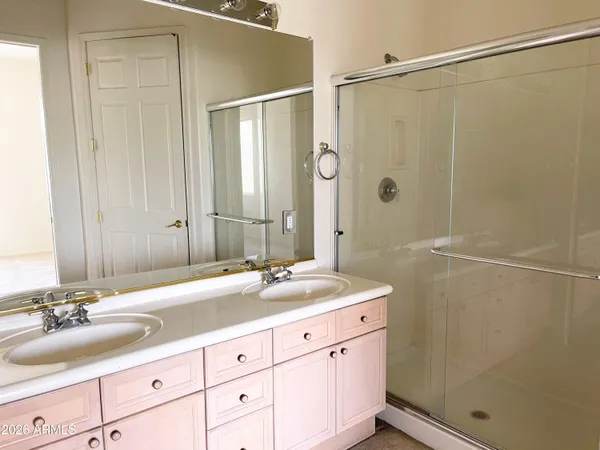 a bathroom with a double vanity sink and a mirror