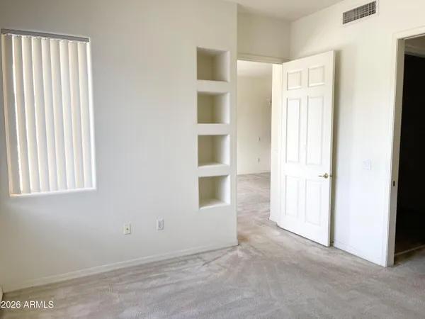a view of an empty room with a window