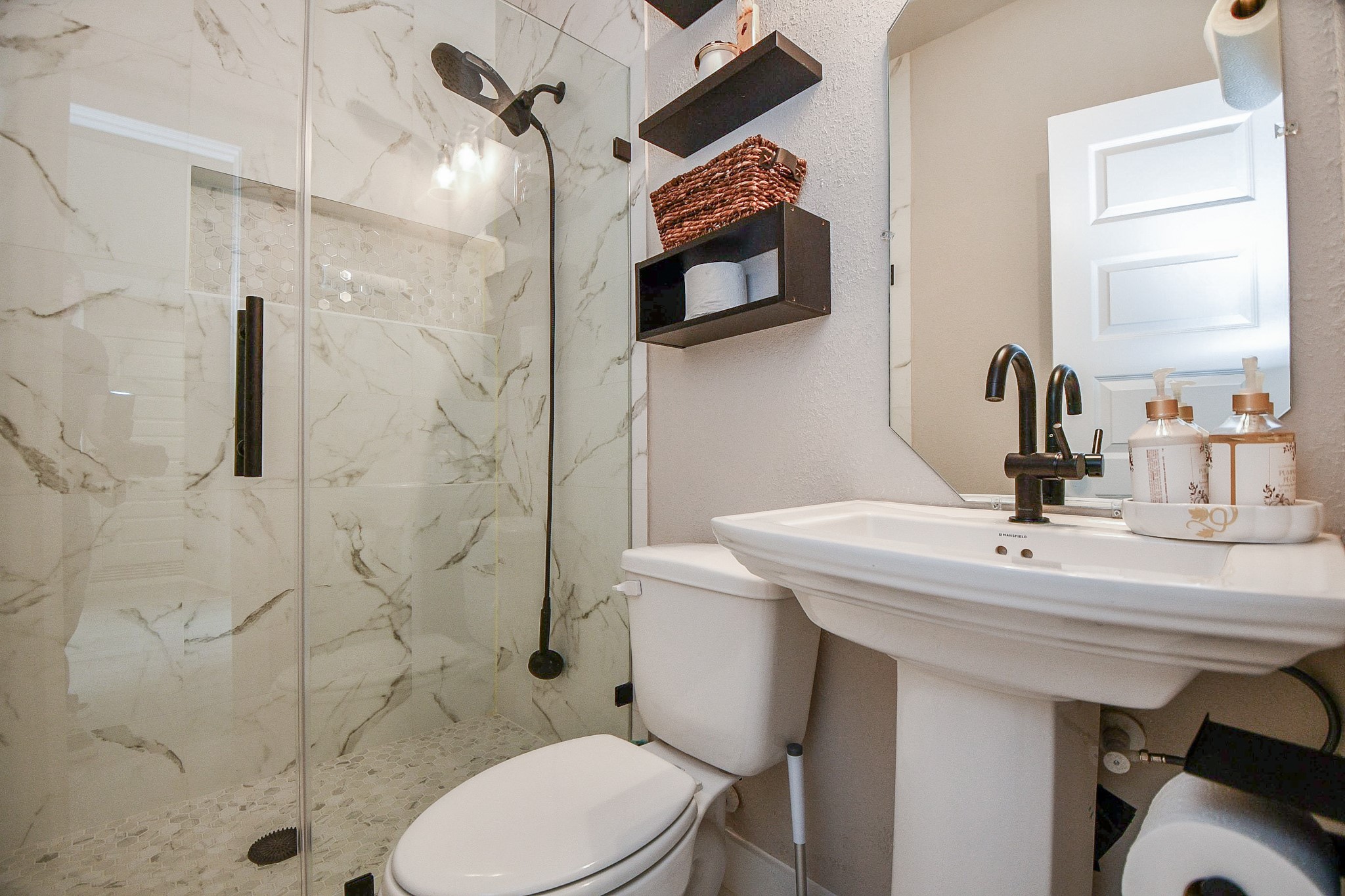 3430 Majestic Pine Lane Rosenberg, TX 77471 - Photo 25 of 32 a bathroom with a sink a toilet and mirror