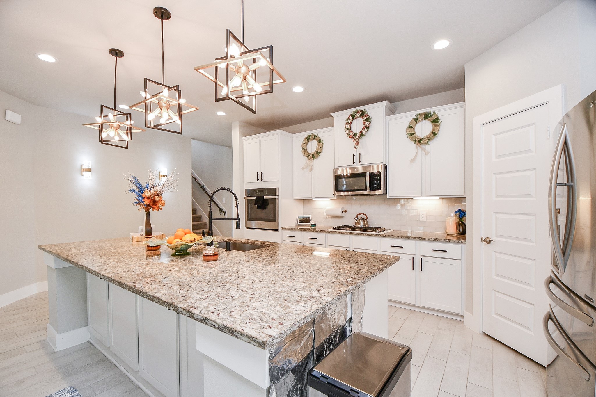 3430 Majestic Pine Lane Rosenberg, TX 77471 - Photo 7 of 32 a kitchen with stainless steel appliances granite countertop a sink dishwasher and a refrigerator with wooden floor