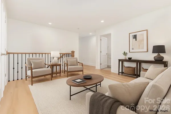 a living room with furniture a rug and a large window