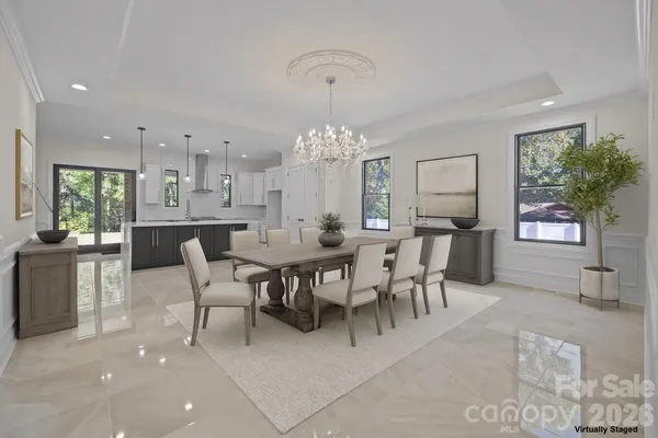 a large kitchen with kitchen island a sink stainless steel appliances and a fireplace