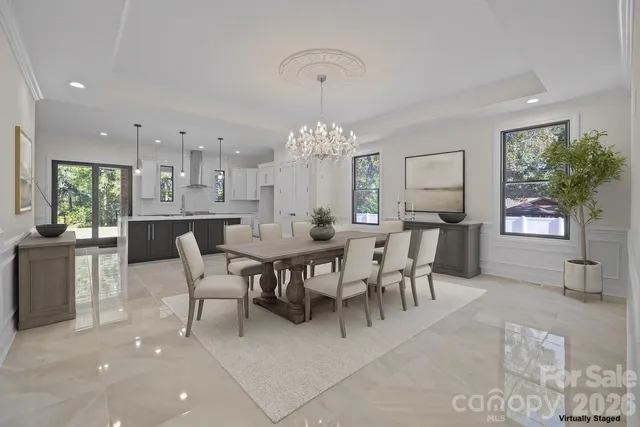 a large kitchen with kitchen island a sink stainless steel appliances and a fireplace