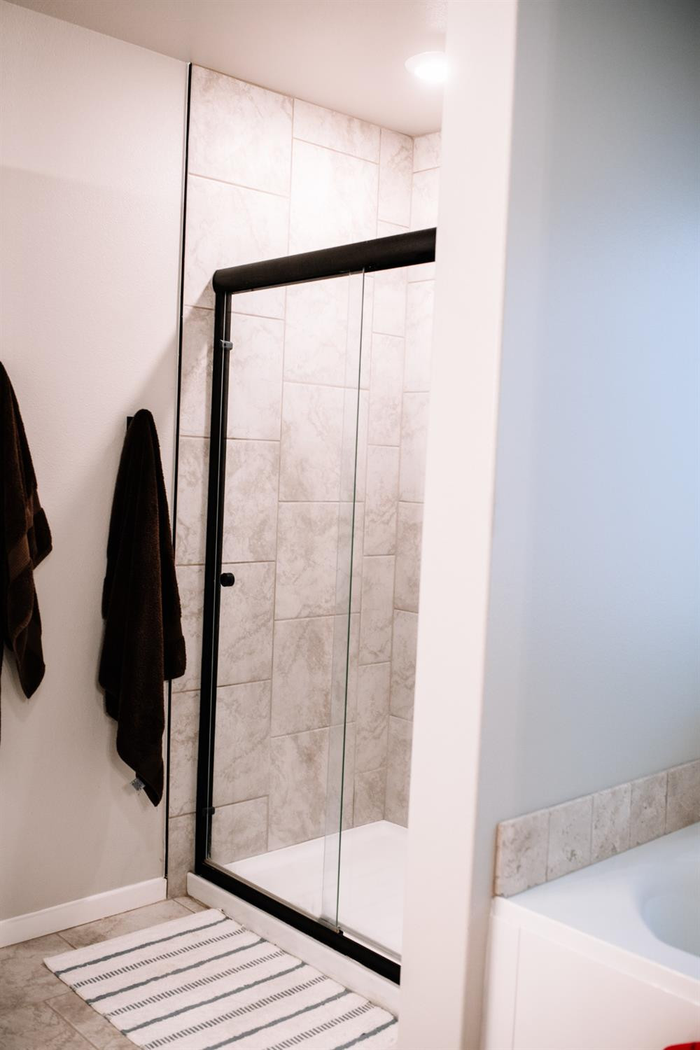 3224 Virginia Avenue Lubbock, TX 79407 - Photo 28 of 39 a bathroom with a glass shower door