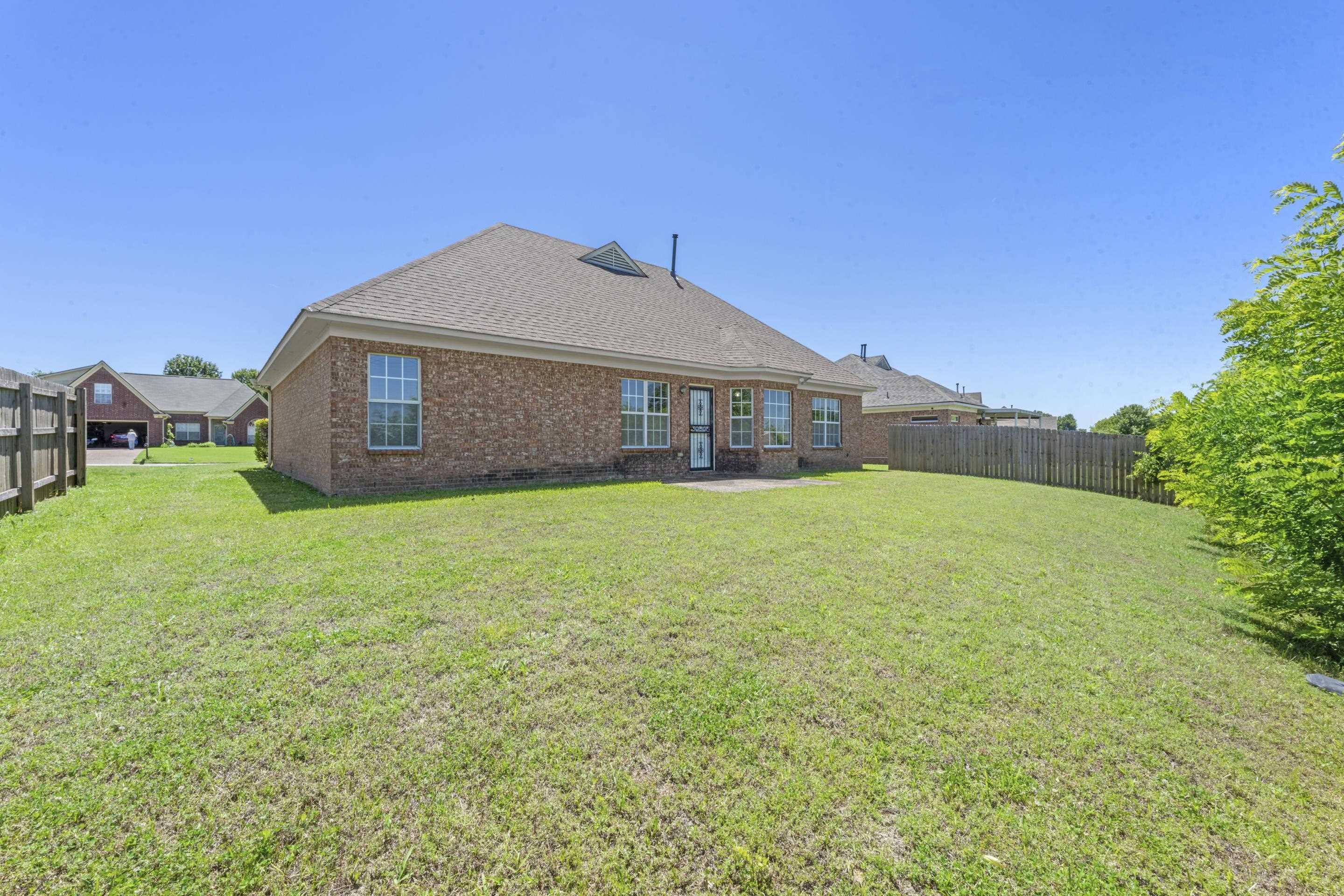 50 Abbey Road Oakland, TN 38060 - Photo 24 of 26 Expansive green lawn with a privacy fence