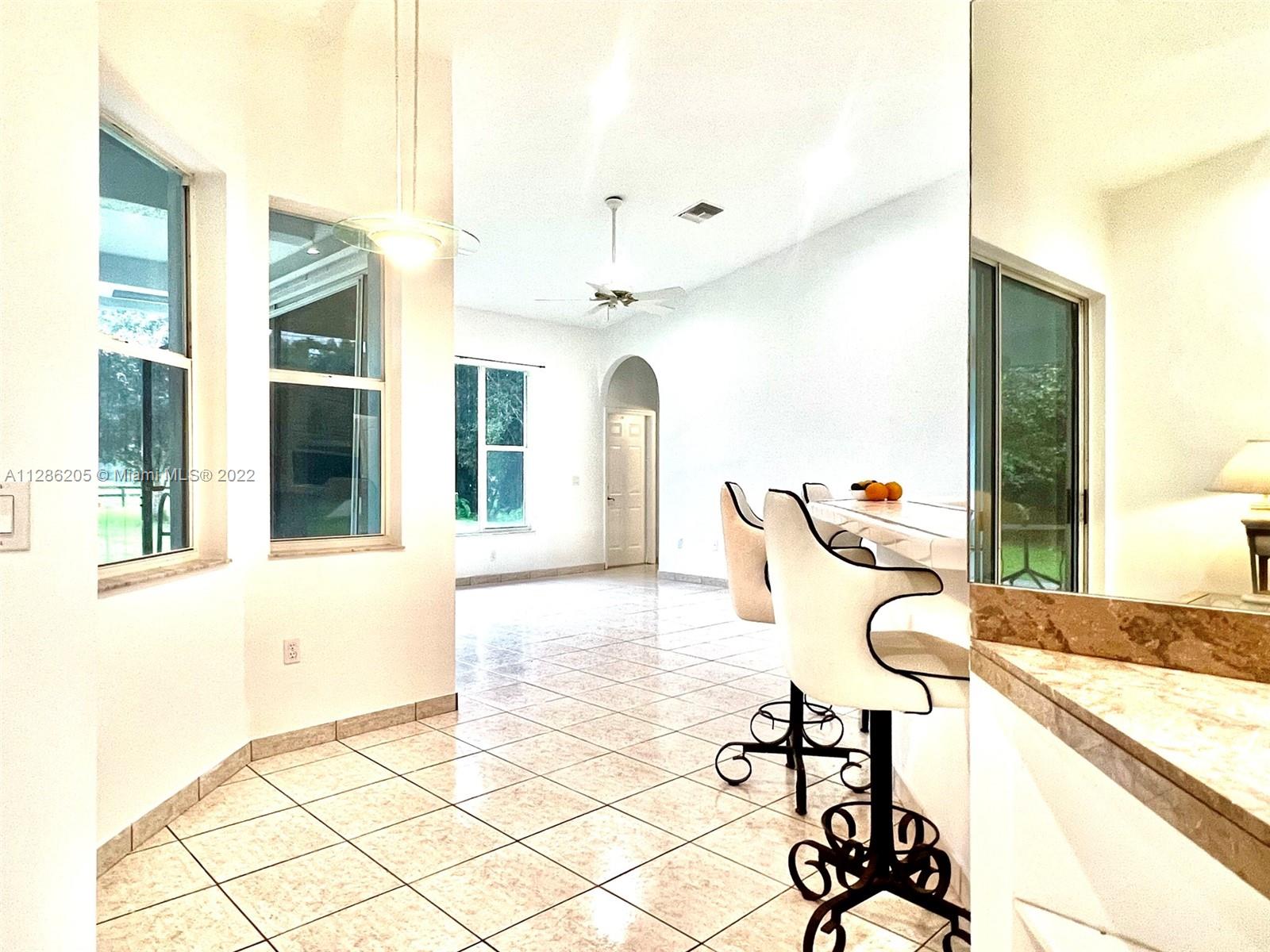 17880 Southwest 66th Street Southwest Ranches, FL 33331 - Photo 30 of 57 a view of a balcony with chairs and chandelier