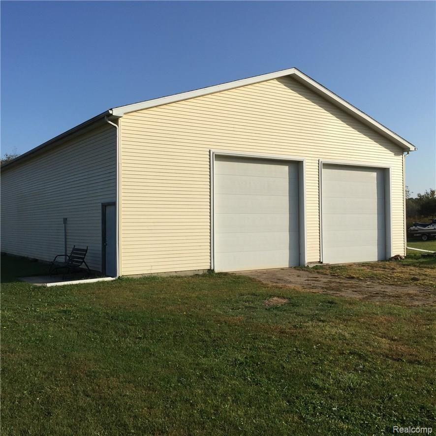 9472 Grant Road Fowlerville, MI 48836 - Photo 25 of 26 12' doors and side entrance to 40' x 64' pole barn.