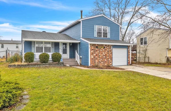 a view of a house with pool and chairs