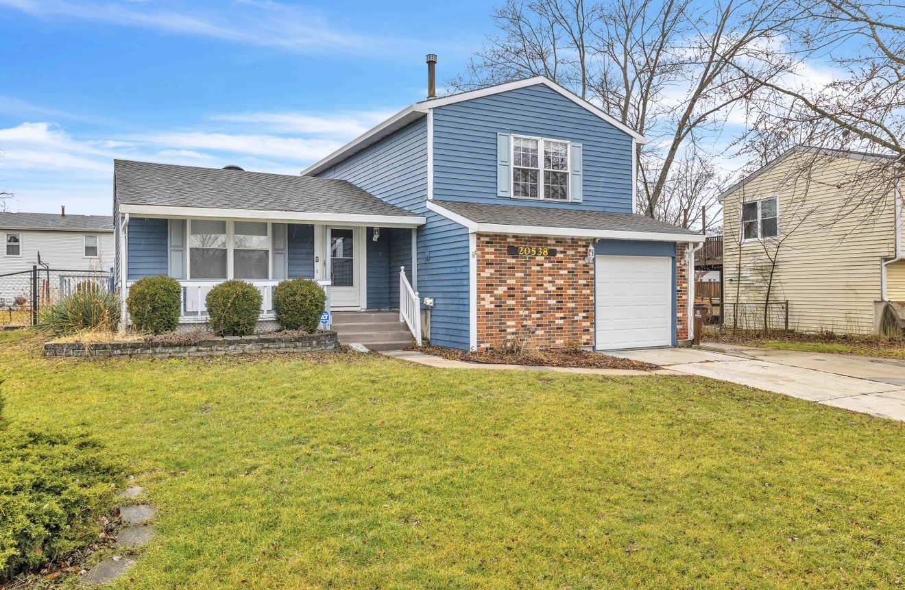 a view of a house with pool and chairs