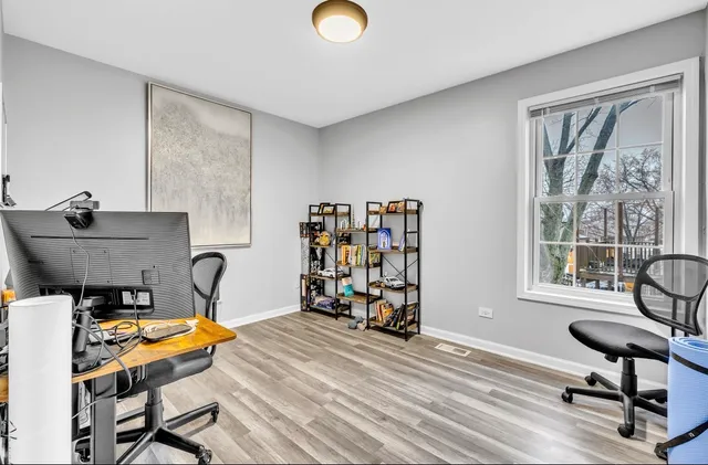 a view of a workspace with furniture and a window