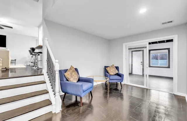 a living room with furniture and a chair