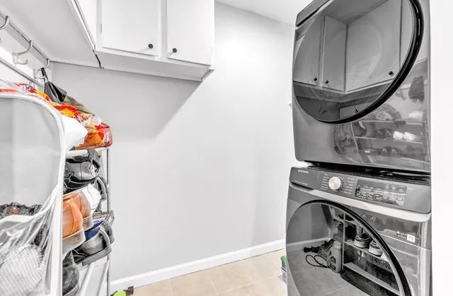 a view of an empty room with wooden floor and windows