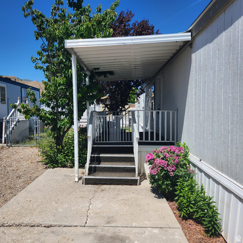 3760 Gold Ridge Drive, Unit 82 Magna, UT 84044 - Photo 2 of 29 Covered porch entry featuring white railings and steps