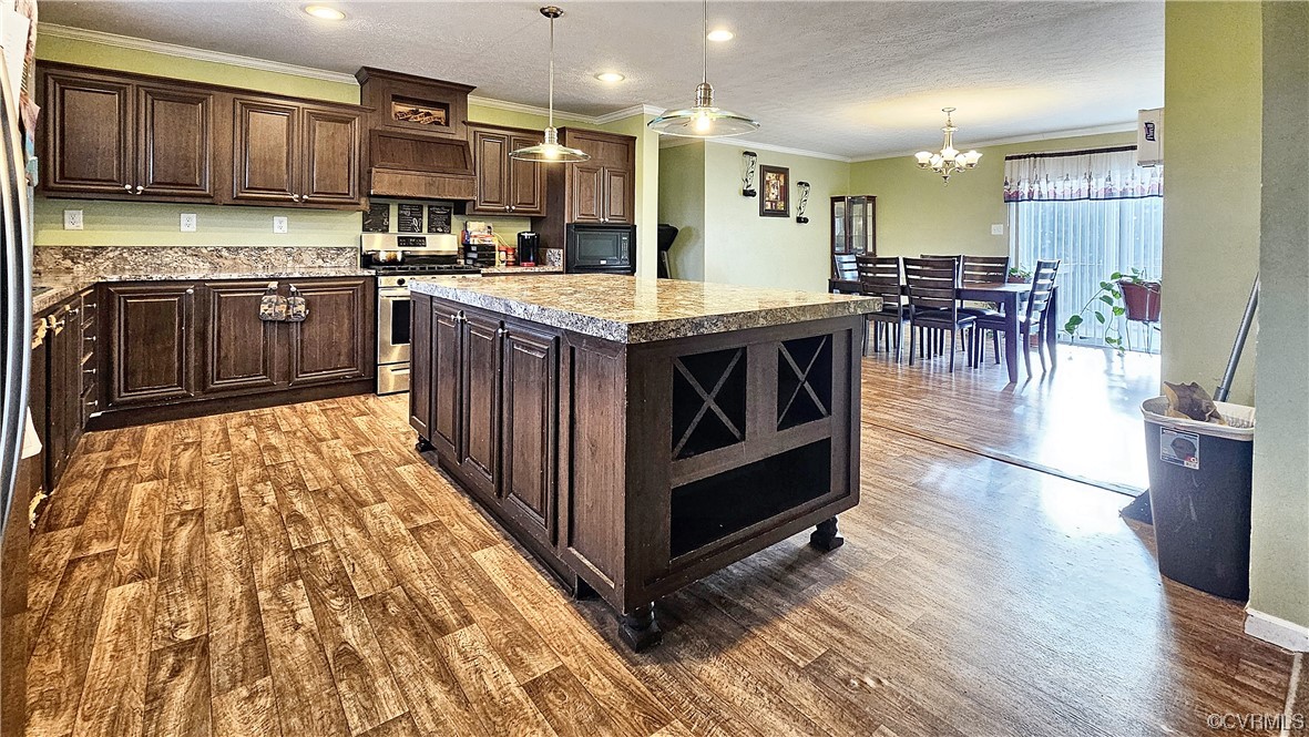 a kitchen with stainless steel appliances granite countertop a stove and a sink