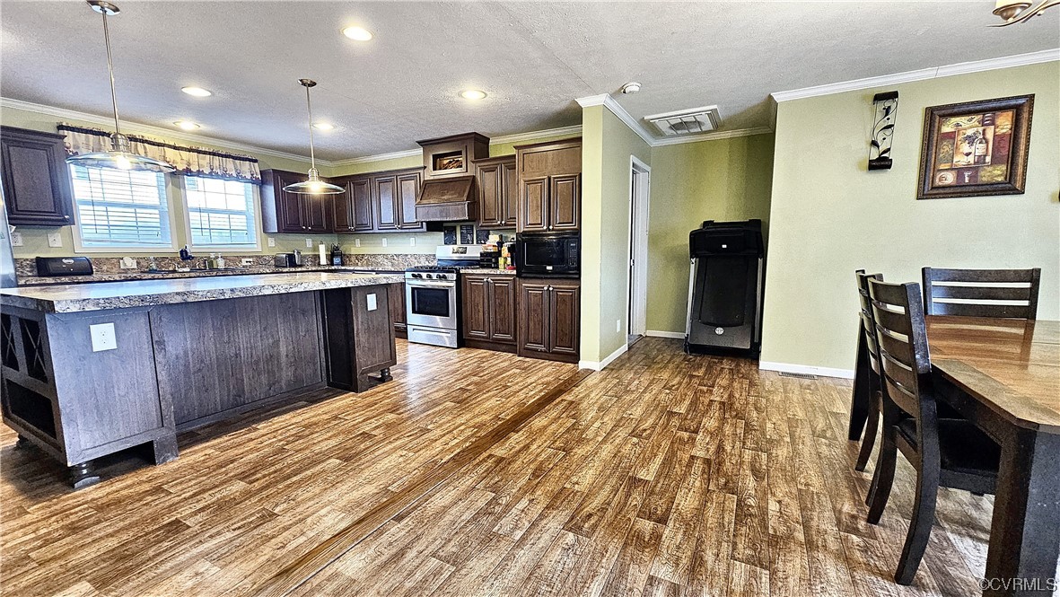 633 Taylors Mill Road Emporia, VA 23847 - Photo 4 of 14 a kitchen with stainless steel appliances granite countertop a refrigerator a stove top oven a sink dishwasher and wooden cabinets