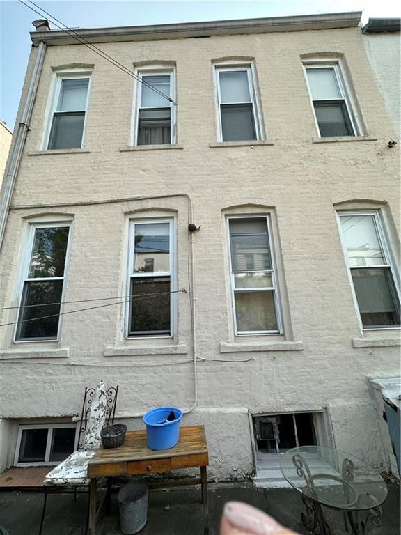 631 Bay Ridge Avenue Brooklyn, NY 11220 - Photo 8 of 9 a front view of a house with many windows