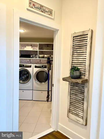 a view of walk in closet with clothes