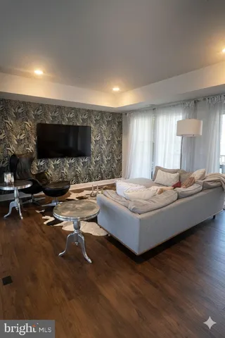a view of a livingroom with furniture and hardwood floor