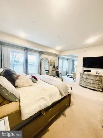 a spacious bedroom with a bed and window