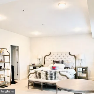 a bedroom with bed and a large window