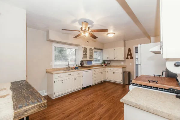 a kitchen with white cabinets and white appliances