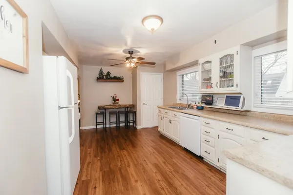 a kitchen with a stove and white cabinets