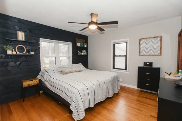a bedroom with a large bed and a large window