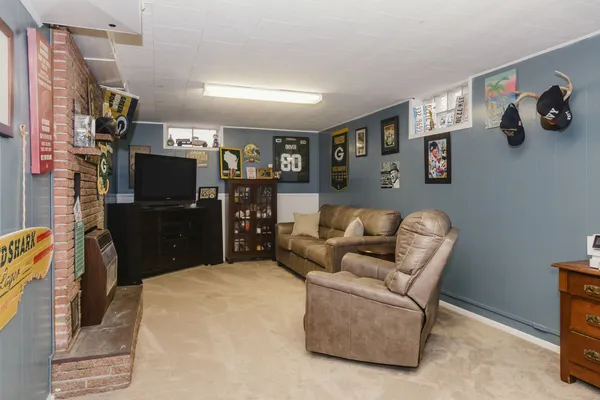 a living room with a couch and a stove top oven