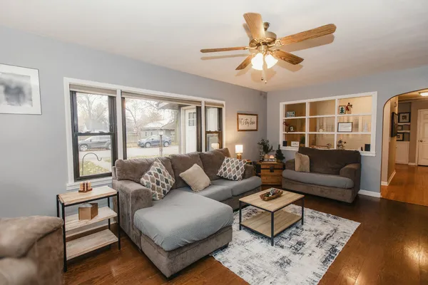 a view of a kitchen with a refrigerator and an empty room